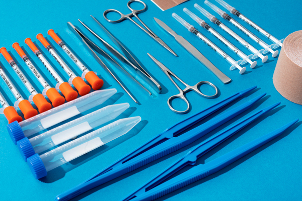 Medical supplies including scissors, tape, and other items commonly used in healthcare settings.